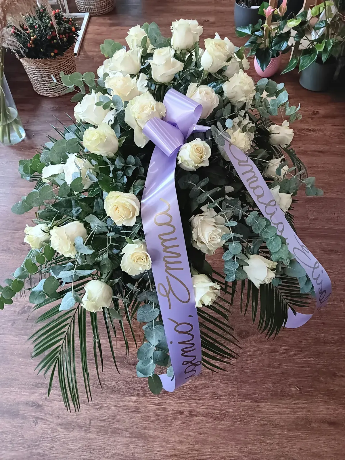 Composizione funebre bianca con nastro lilla